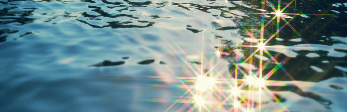 Abstract background from water texture with glitter from reflection of sunlight